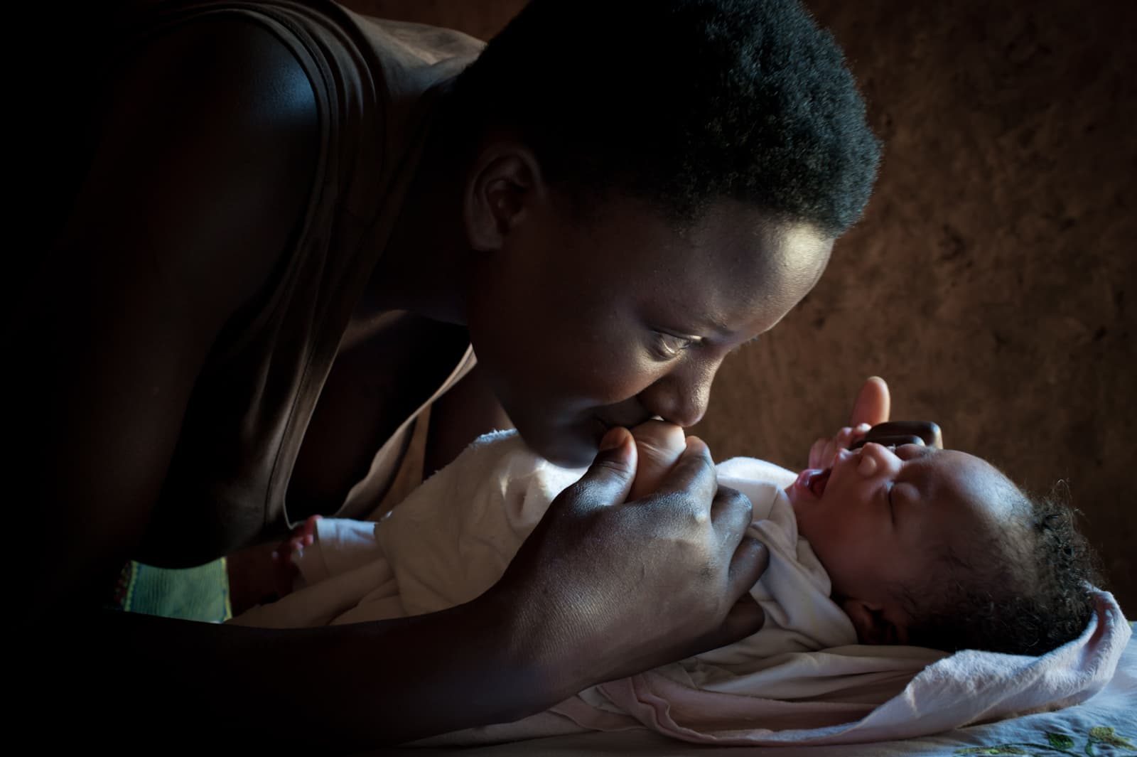 A mother in Rwanda holding her newborn.